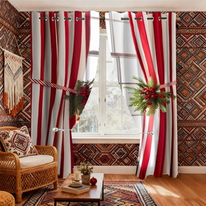 Christmas red and white striped velvet curtains with festive pine branch tiebacks