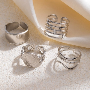Macro view of vintage silver ring set featuring layered crown and moon textures