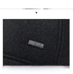 Detail shot of black woolen baseball cap with SPORT engraved metal rectangular plate