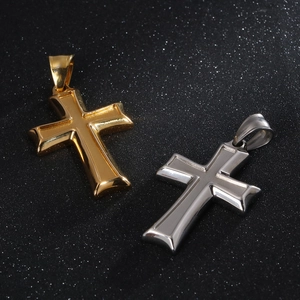 Detailed close-up of high-polish gold and silver cross pendants on a textured background