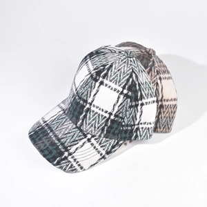 Detail shot of multi-color vintage plaid baseball cap with thick autumn fabric and stitching
