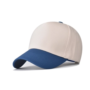 Detail of a two-tone cotton baseball cap featuring cream crown and navy blue brim