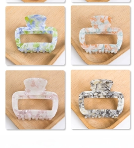 Detail view of 6cm rectangle claw clips with marble ink texture in four colors