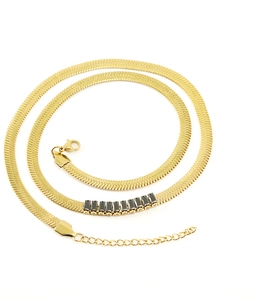 Close-up of 18K gold stainless steel flat snake chain with black zircon stone inlay