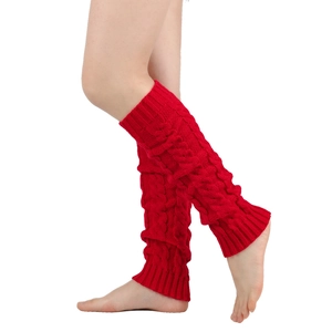 Detail of red cable knit leg warmers showing thick braided texture and ribbed cuffs