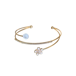 Elegant gold-plated open bangle with flower charm, pearl ball and cubic zirconia inlay