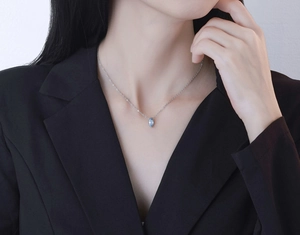 Close-up of a marquise-cut light blue zircon pendant on a silver S925 necklace chain