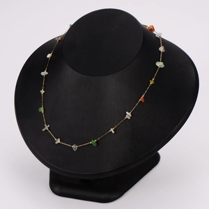 Irregular colorful bohemian stone necklace with gold stainless steel chain on black display