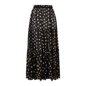 Close-up of black tiered maxi skirt featuring gold polka dot prints and elastic waist
