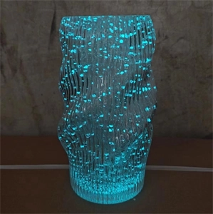 Modern luminous blue glass vase with wave texture and glowing light points for home decor