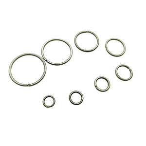Eight sizes of silver-toned metal jump rings for jewelry making on a white background