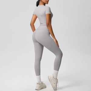 Detail of grey two-piece yoga set showing slim-fit short sleeve top and high waist leggings
