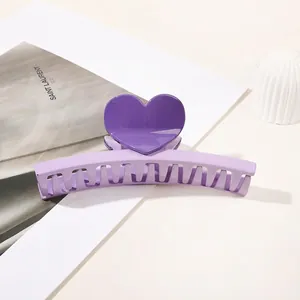 Detailed view of a sweet purple heart hair claw clip on a stylish white background