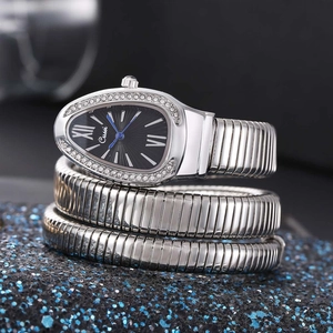 Macro view of silver snake-shaped quartz watch with crystal bezel and black dial