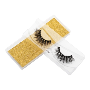 Macro shot of style #103 3D faux mink false eyelashes in a gold glitter box