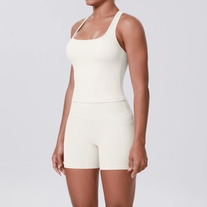 Detailed view of white high-waist fitness shorts with side pockets and smooth seam texture