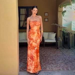Detail of elegant orange floral tube dress with slim fit and satin finish for vacation