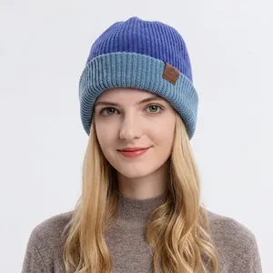 Winter two-tone knitted beanie with faux leather mountain patch for men and women