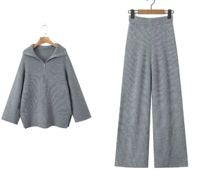 Detail of grey knitted two-piece set with ribbed texture and half-zip collar design