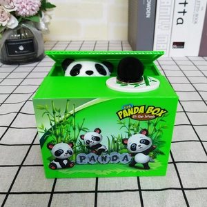 Close-up of cute green electric panda coin bank stealing money from the box