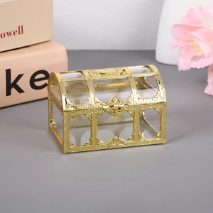 Detailed close-up of hollow gold candy box with transparent window and retro buckle