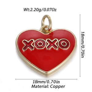 Detail view of a red enamel heart pendant in copper with gold trim and XOXO engraving