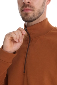 Detail of caramel brown men's polo sweatshirt featuring half-zip collar and knit texture