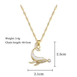 Detail of gold dolphin pendant with pearl and enamel showing 2.5cm height dimensions