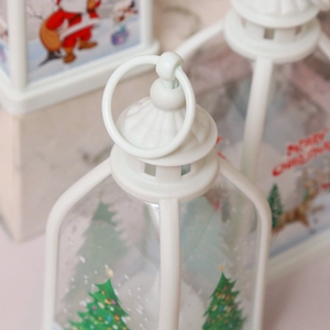 Detail of the hanging ring and festive patterns on a white Christmas lantern