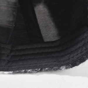 Detailed macro view of black cotton sweatband and reinforced stitching on a checkered cap