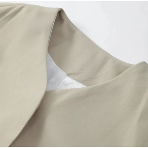 Close-up of khaki blazer notch lapel and shoulder tailoring with fine twill texture