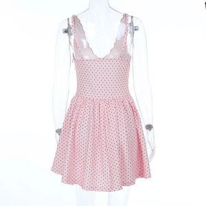Detailed back view of pink polka dot dress featuring elegant lace trim on the V-neckline