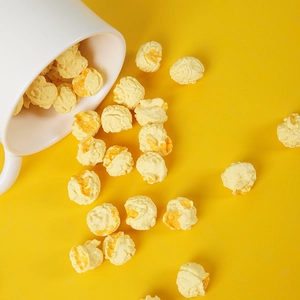 Macro detail of artificial spherical popcorn with realistic yellow caramel coating
