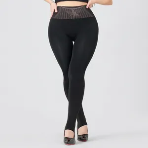 Detail of high-waist black stirrup leggings with butterfly pattern and slimming effect