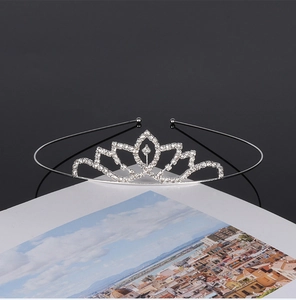 Detailed view of silver rhinestone tiara with lotus floral sparkling metal design