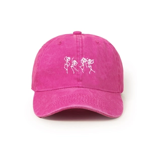 Close-up of dancing skeletons embroidery on a washed rose pink cotton baseball cap