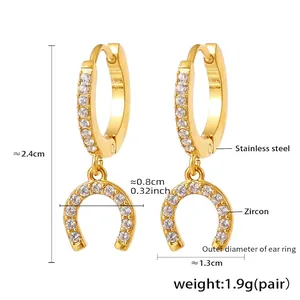 Detail of U-shape horseshoe drop earrings in gold stainless steel with pavé zircon stones