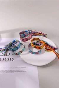 Detail of colorful woven friendship bracelets with bohemian geometric patterns and tassels
