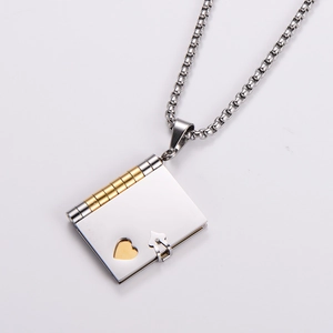 Close-up of heart locket book pendant with silver and gold stainless steel finish