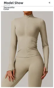 Detail of clay-colored zip-up yoga jacket with stand collar and thumbhole cuffs