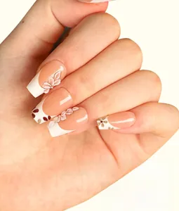 Detailed view of French press-on nails with 3D white flower petals and nude pink base