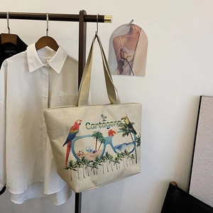 Detail view of large linen tote bag with tropical parrot print and Cartagena branding