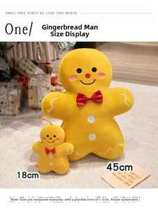 Detail of plush gingerbread man toy with red bow and white embroidery in warm festive setting