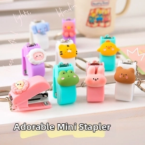 Close-up of cute cartoon animal mini stapler keychains with colorful charms and metal rings