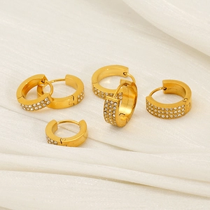 Elegant gold-plated micro-pave hoop earrings with zircon stones on white silk backdrop