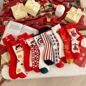 Detailed embroidery on festive red New Year cotton socks with lucky Chinese characters