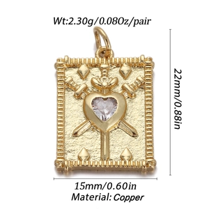 Detailed macro view of gold-plated copper tarot Three of Swords pendant with heart gemstone
