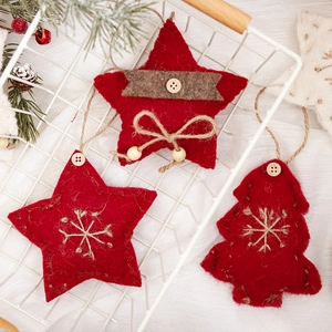 Handmade red felt Christmas ornaments with star and tree shapes in white wire basket