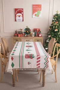 Detail of Christmas tablecloth with red-green festive print and white fringe tassels