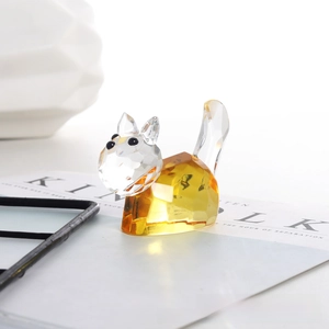 Macro shot of faceted crystal cat figurine with amber yellow body and clear head detail